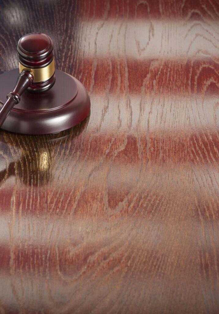 Wooden Gavel Resting on American Flag Reflecting Table