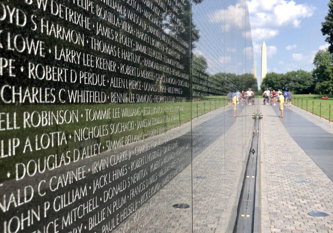 People visiting the Vietnam Veterans Memorial Wall in Washington DC